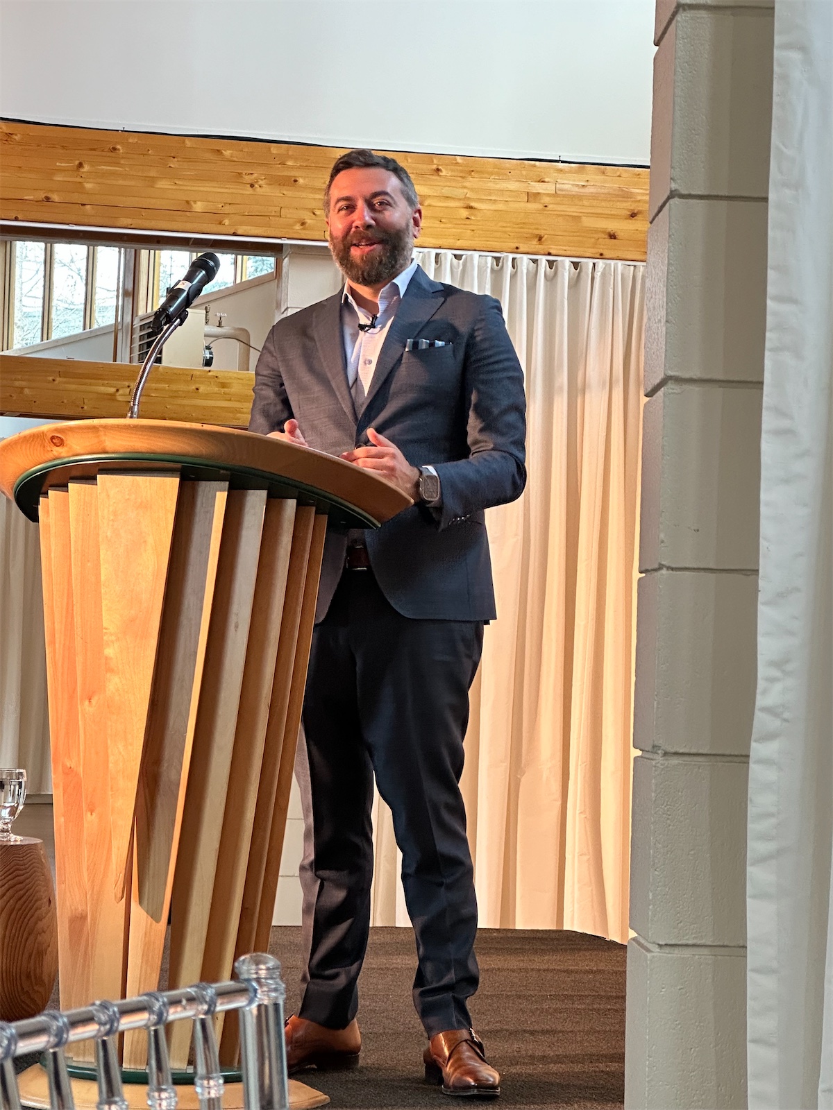Matt Shupe speaking from a wooden lectern at a Leadership Institute training in Canada
